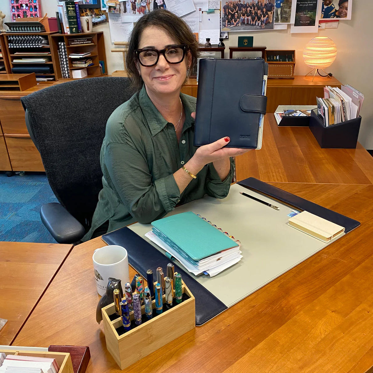 A thoughtfully arranged Levenger Circa discbound notebook kit on a desk: notebook, assorted refills, discs, and a pen laid out as a custom bundle.