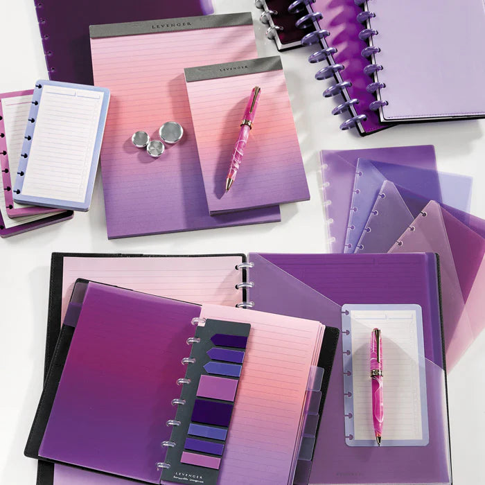 A clean desktop with a tabbed Circa notebook open to a project plan, a small stand displaying a row of labeled index cards, and colorful tabs ready for sorting ideas.