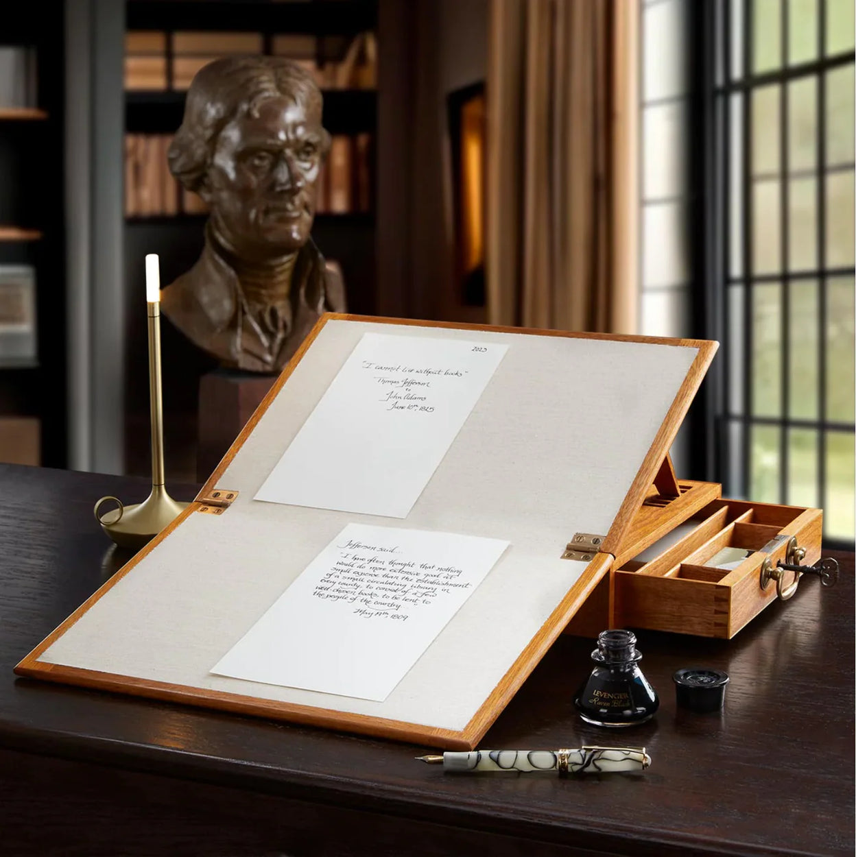 A refined desktop with a cherry pen wheel, a glass‑lidded display case, and a leather desk organizer presenting favorite pens neatly