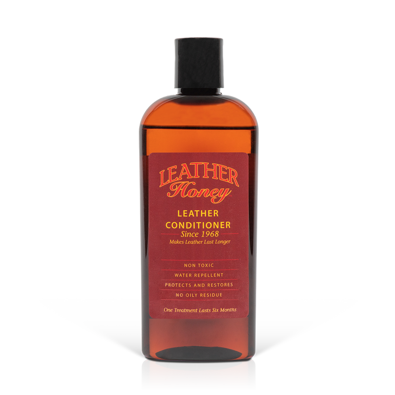 Amber bottle of Leather Honey Leather Conditioner with a black cap.