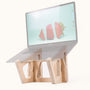 MacBook Pro on a Birch Laptop Lifter with an angled screen displaying a strawberry wallpaper